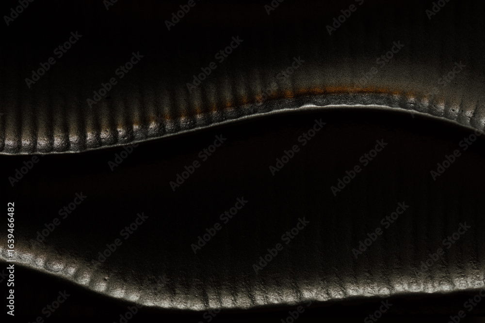 Poster high-resolution image of a dark, textured surface with subtle light patterns. perfect for background