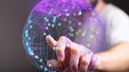 Abstract image of a hand interacting with a digital sphere representing global network connections and data visualization.