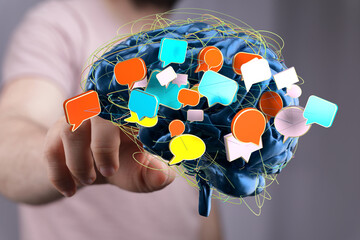 Conceptual image: Brain with colorful speech bubbles, representing communication, ideas, and mental...