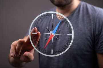 Close-up of a man using a digital compass app, showing navigation and direction.