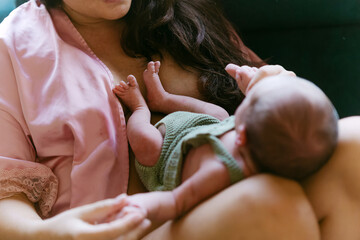 Newborn baby lying on mother’s lap showing bond and connection