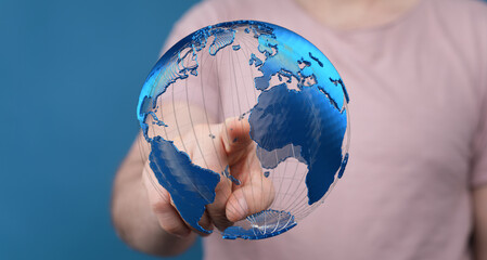 Person interacting with a digital globe, representing global network, technology, and connection.