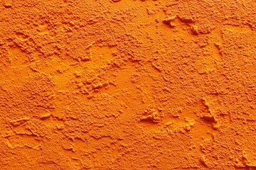 Naklejka premium Vibrant bright orange textured abstract wall backdrop for contemporary design and innovative projects