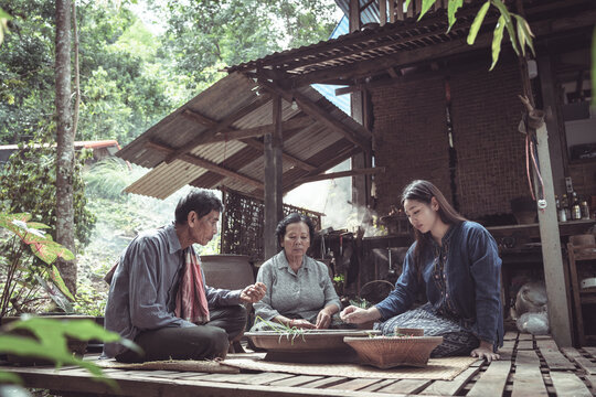 Traditional Family Gathering in Nature, Engaging in Cultural Cooking Practices and Storytelling, Celebrating Heritage in a Rustic Setting