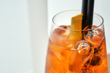 Macro shot of Aperol spritz cocktail with ice and citrus