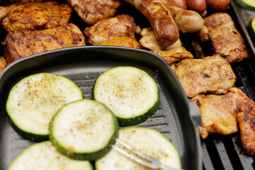 Delicious grilled chicken, sausages, and zucchini seasoned with herbs. Perfect summer BBQ!