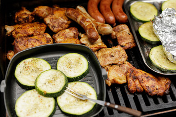Delicious grilled chicken, sausages, and zucchini. Perfect summer meal!