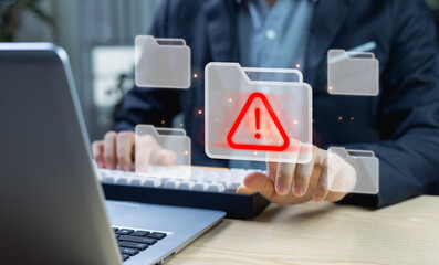Hands interacting with digital file folders and cybersecurity alert icons. Concept of protection from malware, viruses, spyware, and cyberattacks on computer networks and data systems.