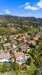 Aerial view luxury homes with hillside.