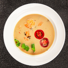 Tom kha soup shrimp, coconut milk, miso paste tasty seafood snack fresh delicious gourmet food background on the table rustic food top view copy space pescetarian diet