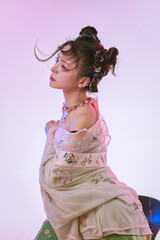 Young woman in elegant traditional clothing with styled hair.