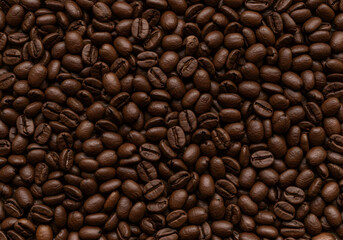 Fototapeta premium Roasted coffee beans background texture. Top-down, close-up view of aromatic, whole roasted coffee beans, perfect as a full-frame background for cafe menus or food-related content.
