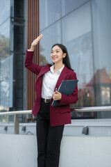 Fototapeta premium Lifestyle of office workers, Woman successful standing front of a modern office building.