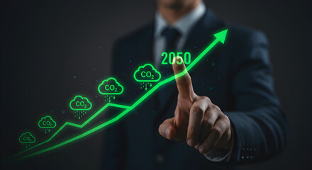 Businessman pointing at a CO2 reduction chart for 2050. A professional touches a holographic graph showing a strategy for achieving carbon neutral or net zero emissions, representing ESG and sustainab