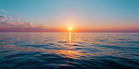 Obraz premium distant sun melting into calm ocean