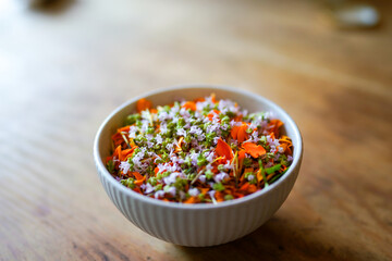 Close up of a white bowl filled with colorful edible flowers