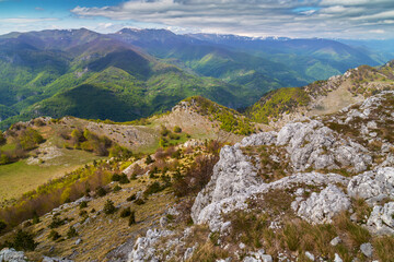 Dramatic scenery with clouds and lush green flora in the Carpathians Mountains in spring