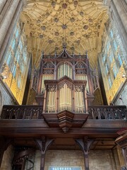 Organ pipes and ornate ceiling inside an English Abbey