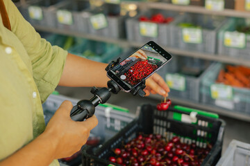 Middle-aged woman blogger filming on the farm market. Mature Female Customer Shopping At Farmers...