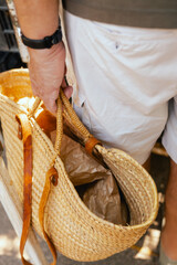 Close up of buyer with shopping baskets for vegetables on the local Farmers market. Close up