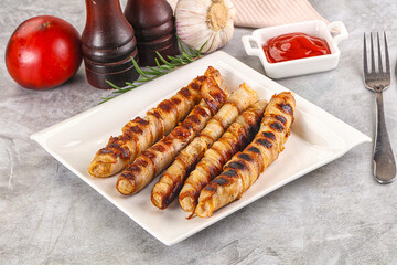Grilled meat sausages wrapped bacon
