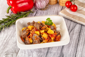 Rogiut with meat, potato and tomatoes