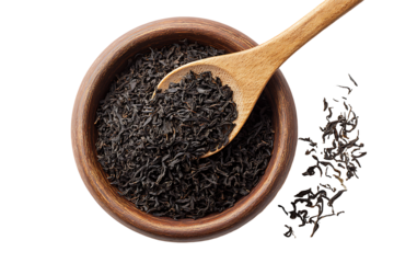 Wooden spoon scooping loose black tea leaves from bowl isolated on transparent background