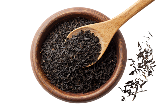 Wooden spoon scooping loose black tea leaves from bowl isolated on transparent background