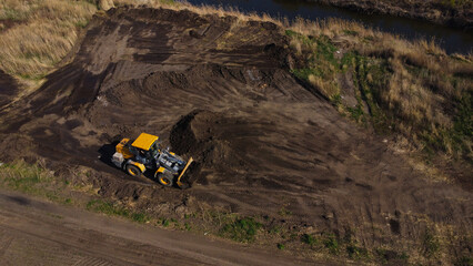 Aerial View of a Yellow Loader Working on Land Development