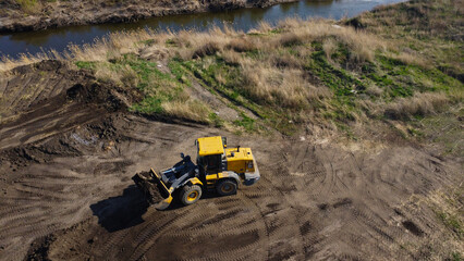 Aerial View of a Yellow Loader Working on Land Development