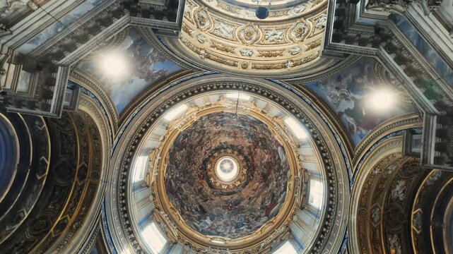 Rome, ITALY, JULY 29th, 2025 - Interior dome of Sant&rsquo;Agnese in Agone with baroque frescoes, golden architectural details, and sacred religious artwork in historic cathedral