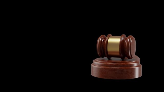 A wooden judge's gavel is featured prominently against a black backdrop for video or 3d render use in legal concepts