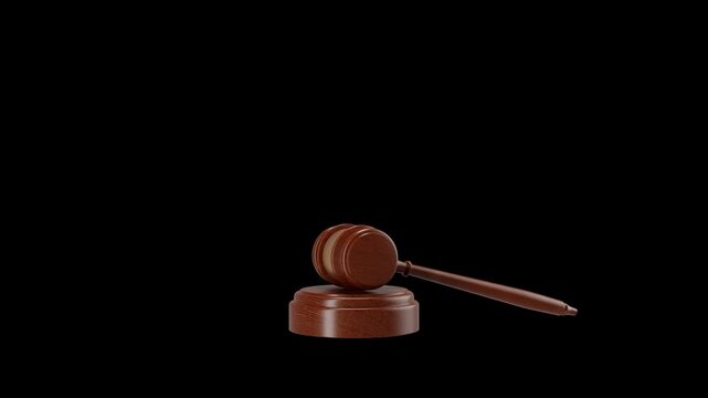 A wooden gavel laying on dark surface, could be used in 3d renders or as a key in legal based video work