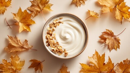 Organic yogurt bowl surrounded by fallen maple leaves. Premium product
