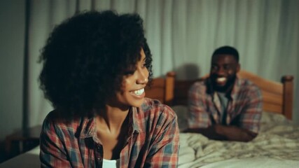 Joyful Gaze: A candid moment captured as a woman turns, radiating joy, while a man chuckles merrily, their connection palpable in this intimate setting.