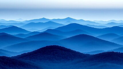 Fototapeta premium Misty mountain range painted in shades of blue.