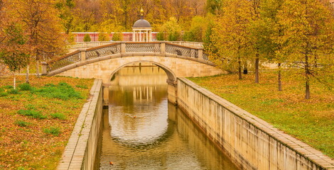Rotunda with a bridge in the autumn park