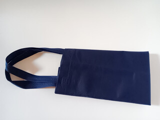 Blue canvas tote bag isolated on white background. Reusable bag for shopping and groceries.
