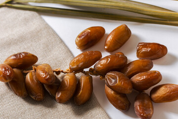 Fresh Organic Dates with Palm Leaves on Linen Cloth