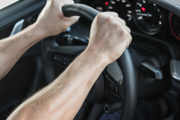 Hands Gripping Steering Wheel While Driving in a Modern Car Interior