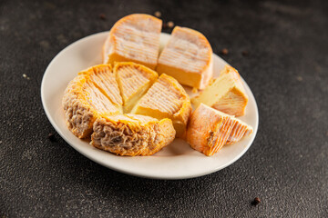 Cheese plate camembert, brie, munster french cheese tasty snack fresh delicious gourmet food background on the table rustic food top view copy space