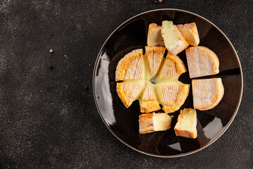 Cheese plate camembert, brie, munster french cheese tasty snack fresh delicious gourmet food background on the table rustic food top view copy space