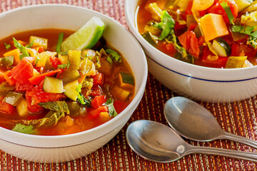 vegetable stew with zucchini, sweet potato, and kale in a tomato broth