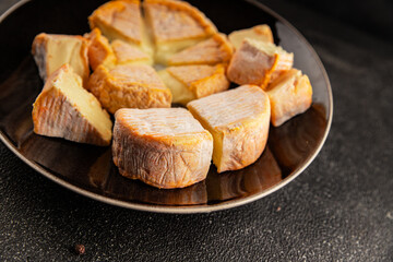 Cheese plate camembert, brie, munster french cheese tasty snack fresh delicious gourmet food background on the table rustic food top view copy space