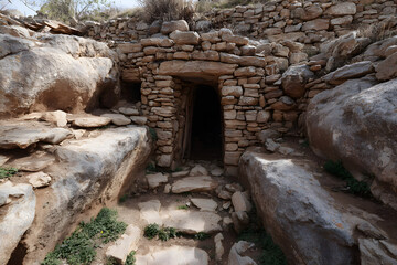 Ancient subterranean dwelling with a stone gateway