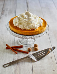 pumpkin cheesecake with ginger snap crust topped with whipped cream