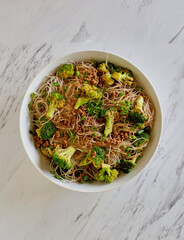 beef and broccoli tossed with rice noodles in a ginger soy sauce