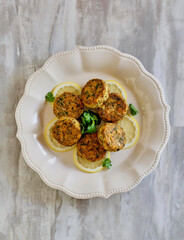 fresh salmon patties made with fresh lemon and parsley, isolated