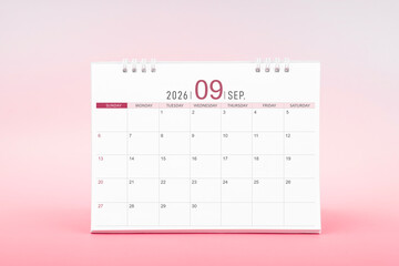 September blank desk calendar for 2026 year on pink color background.