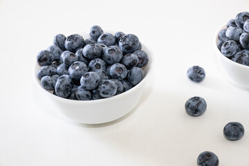 Blueberry is tasty, healthy and delicious fruits. Fresh blueberries  in white bowl. Wild blueberries in white plate on white background.